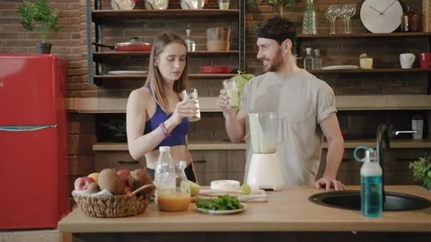 Zooming in slow motion view of young couple tasting organic smoothie for the Stock Footage 111959632