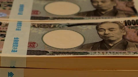 Zooming in on a stack of 10 million yen bills Stock Footage 336264033
