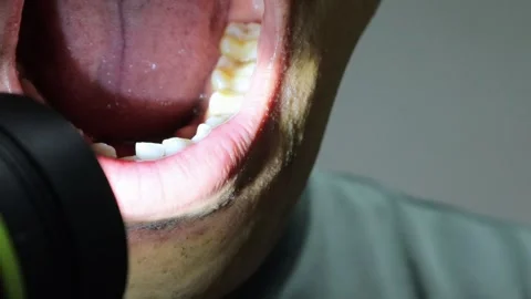 Zooming in on teeth with a flashlight Stock Footage 323501703