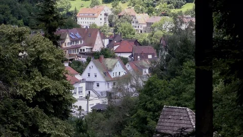 Zooming through forrest on German mountain village Stock Footage 97899081