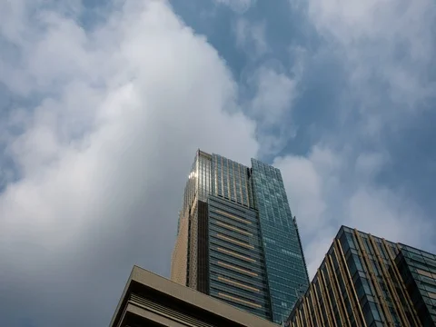 Zooming timelapse of white clouds over office building in the Roppongi area Stock Footage 80618699