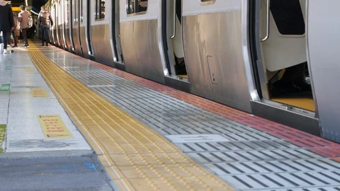 Zooming in to the train door in lower view on train's platform Stock Footage 122685091
