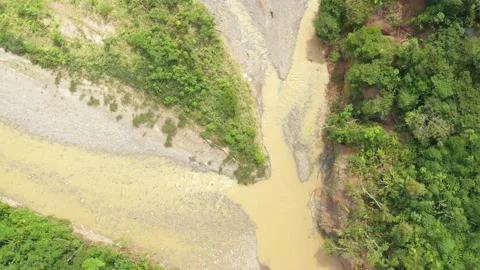 Zooming in very slowly at two small rivers with a brown color from the mud Stock Footage 142759566