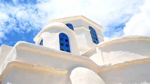 Zooming in on a white washed chapel with blue windows in the island of Sifnos. Vídeos de archivo 334010237