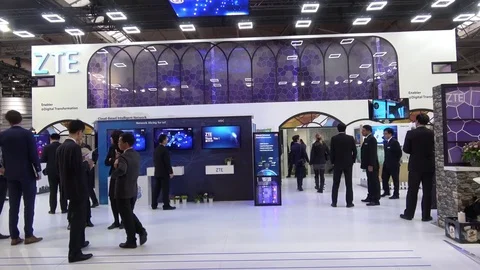 ZTE is a provider of advanced telecommunications stand interior on exhibition Stock Footage 74110279
