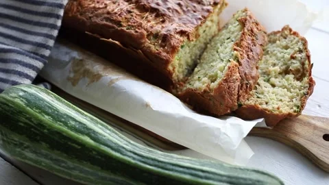 Zucchini and cheese bread, a loaf of bread on a wooden cutting board. Stock-Footage 314886564