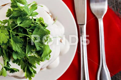 Zucchini cake and eating utensils on a red napkin Stock Photos