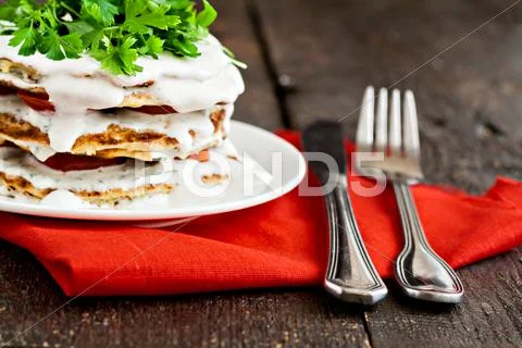 Zucchini cake and eating utensils on a red napkin Stock Photos