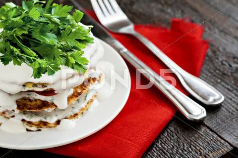 Zucchini cake and eating utensils on a red napkin Stock Photos