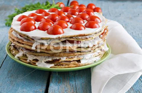 Zucchini cake with tomato and parsley on a blue wooden Stock Photos