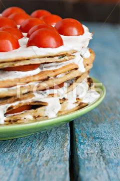 Zucchini cake with tomatoes on a blue wooden background Stock Photos