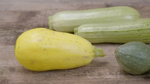 Zucchini of different varieties and types on a wooden background. Stock Footage 115691296