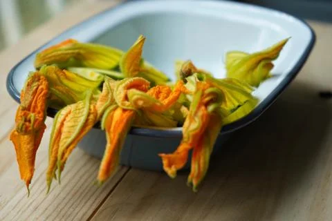 Zucchini flowers in a plate. Closeup Stock Photos