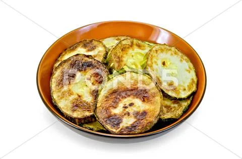 Zucchini fried in ceramic ware Stock Photos