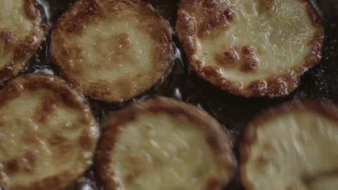 Zucchini fried in oil in a pan move with a kitchen fork Stock Footage 337112812