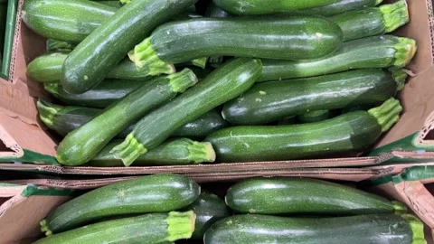 Zucchini or  courgettes displayed in cardboard crate Stock Footage 312707954