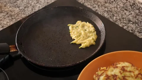 Zucchini pancakes cooked in frying pan Stock Footage 320927208