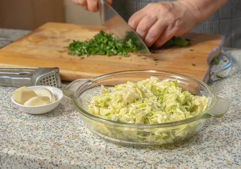 Zucchini pulp grated on a grater for making pancakes in a glass plate again.. Stock Photos