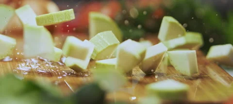 Zucchini sliced falling on board 스톡 동영상 311834748