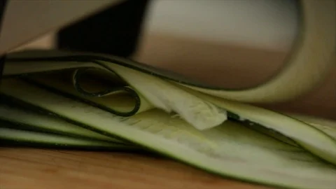 Zucchini is sliced into very thin Slices Closeup Stock Footage 99166267
