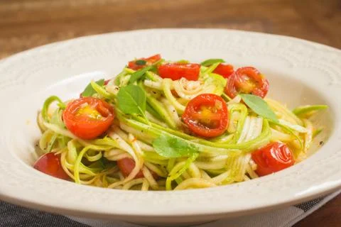 Zucchini Spaghetti with cherry tomatoes Stock Photos