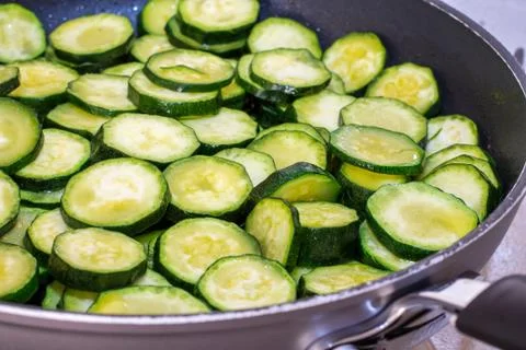 Zucchini while cooking Stock Photos