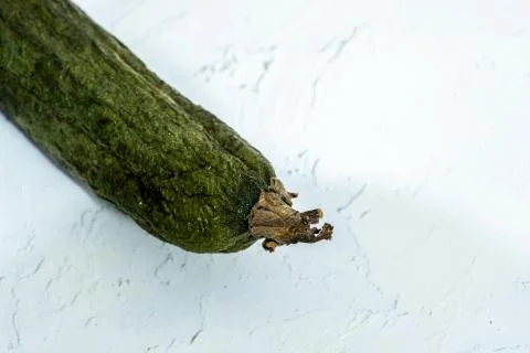 Zucchini on a white table with space for text Stock Photos