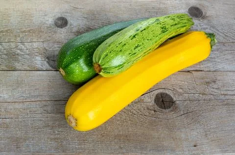 Zucchini on a wooden background. Stock Photos