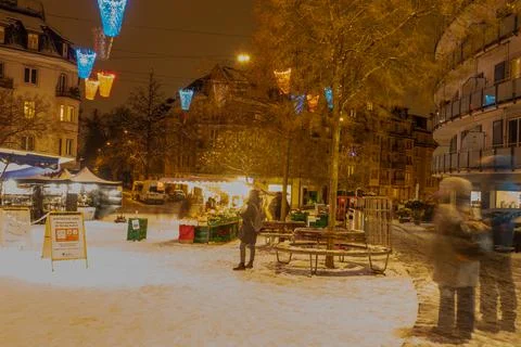 Zuerich, Switzerland - January 12th 2020: Snowy winter evening at a market place Stock Photos