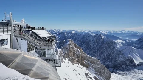Zugspitze viewpoint with visitors overlooking snowy alpine peaks Stock Footage 331941891