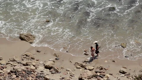 ZUMA Beach, CA  - July 3,  2014 Couple Walking Down A California Beach Stock Footage 169056484