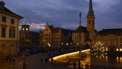 Zurich münsterbrücke river night fraumunster church panorama 4k switzerland Stock Footage